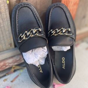 Aldo Black Loafers with Gold Chain Accent.